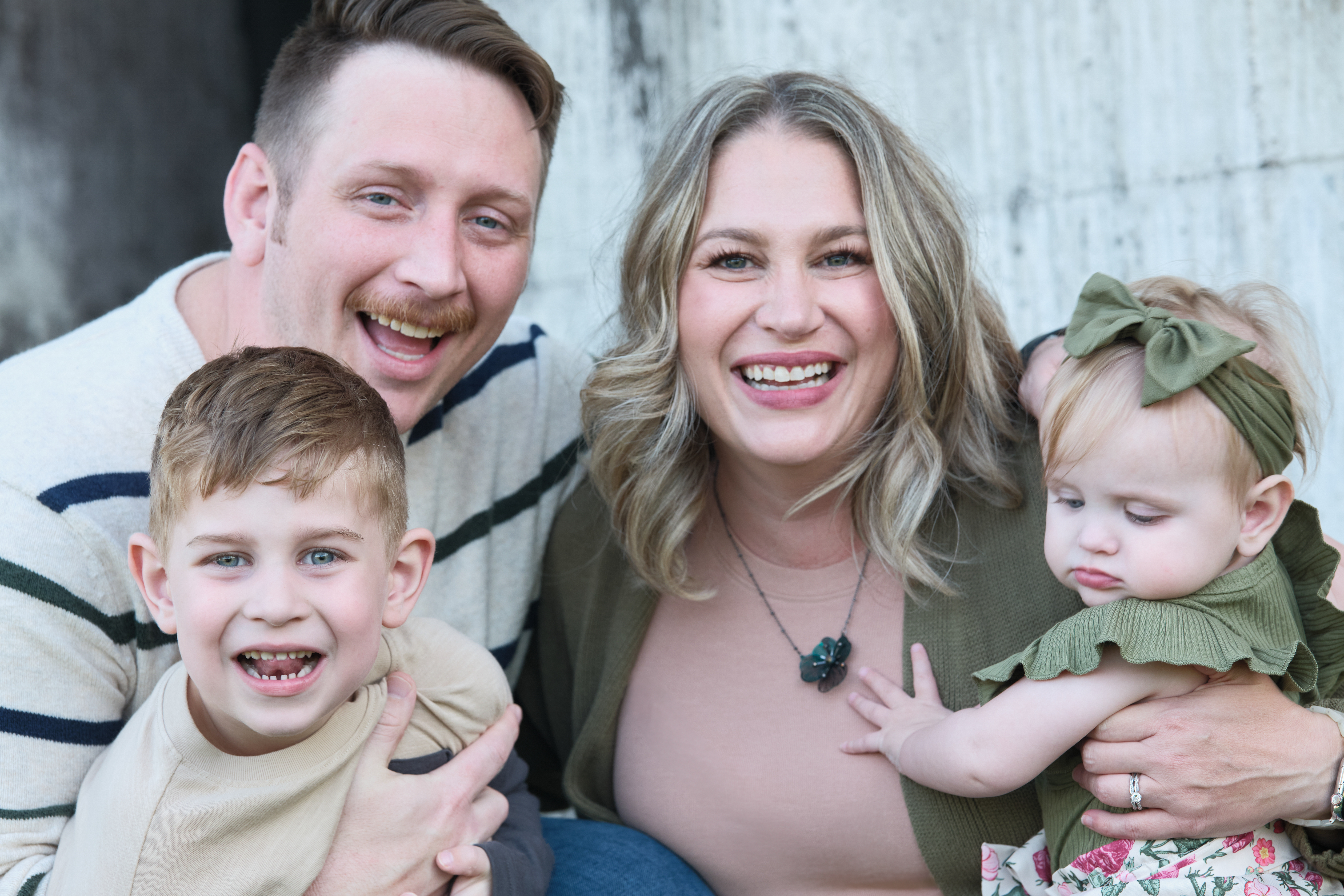 A photograph of a married couple and their two kids.